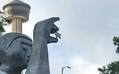 Tower of the Americas and sculpture in San Antonio, part of the self-guided city exploration game.