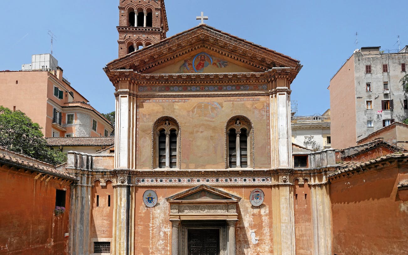 Basilica of Santa Pudenziana facade with bell tower in Rome.