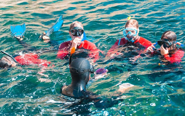 Snorkelers in Arrábida Natural Park exploring clear waters.