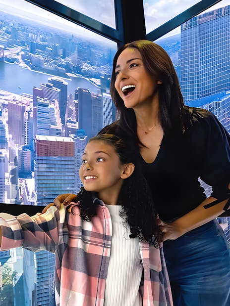 Visitors enjoying digital skyline display in One World Observatory elevator, New York City.