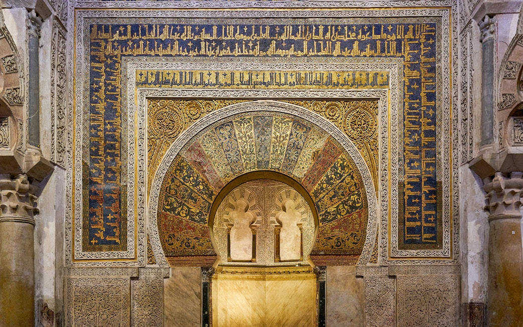 Mihrab of the Cordoba Mosque-Cathedral with intricate gold and blue mosaics.