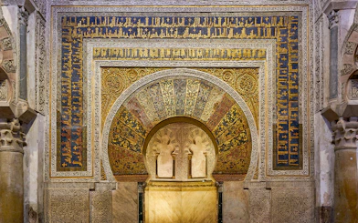 Mihrab of the Cordoba Mosque-Cathedral with intricate gold and blue mosaics.