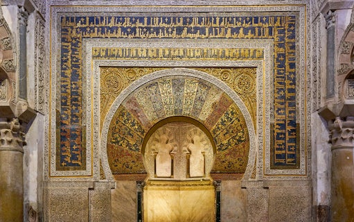 Mihrab of the Cordoba Mosque-Cathedral with intricate gold and blue mosaics.