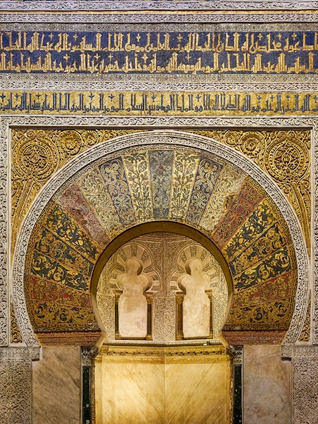 Mihrab of the Cordoba Mosque-Cathedral with intricate gold and blue mosaics.
