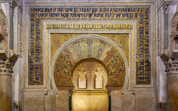 Mihrab of the Cordoba Mosque-Cathedral with intricate gold and blue mosaics.