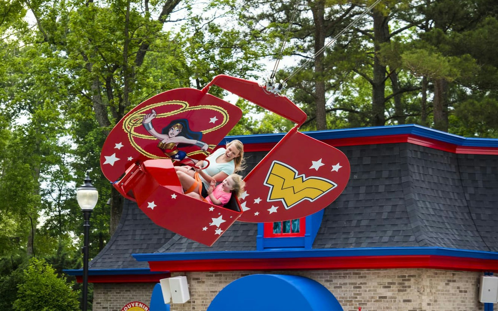 Visitors enjoying WONDER WOMAN™ Flight School ride at Six Flags Over Georgia.