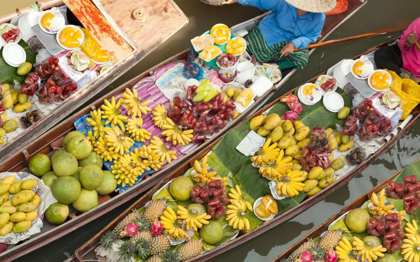 Boats with tropical fruits at Damnoen Saduak Floating Market, part of Ayutthaya tour from Bangkok.
