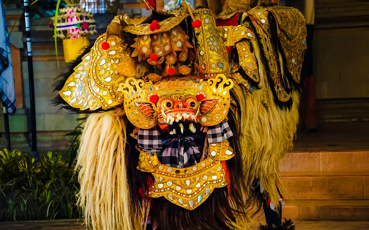 Uluwatu Kecak & Fire Dance performer in ornate golden costume.