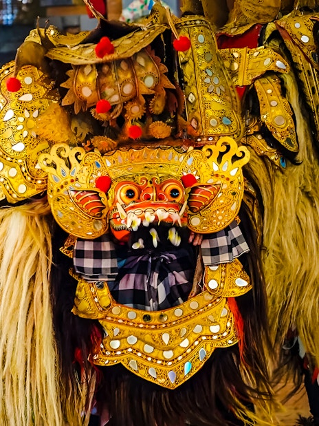 Uluwatu Kecak & Fire Dance performer in ornate golden costume.