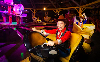 Visitors enjoying a cowboy-themed ride at Sunway Lagoon night park.