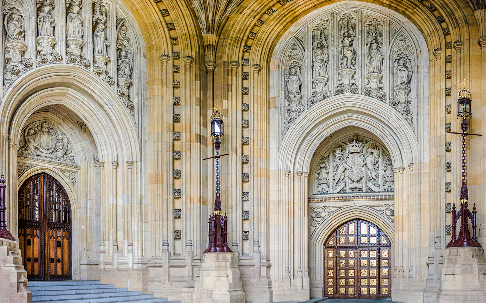 Central Lobby entrance with ornate arches and detailed stone carvings at Houses of Parliament, London.