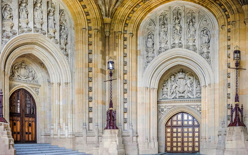 Central Lobby entrance with ornate arches and detailed stone carvings at Houses of Parliament, London.