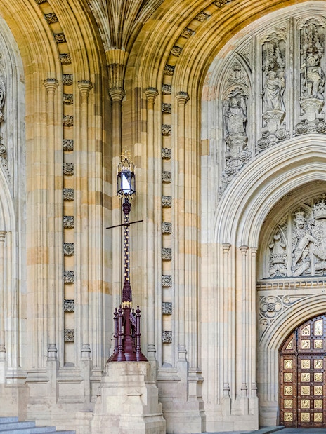 Central Lobby entrance with ornate arches and detailed stone carvings at Houses of Parliament, London.