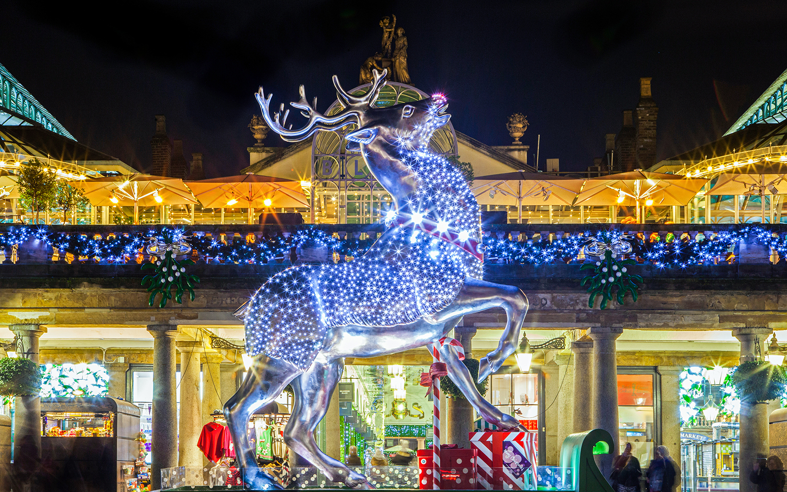 Illuminated reindeer statue at Covent Garden during London Christmas Lights Tour.