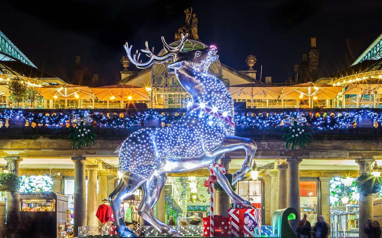 Illuminated reindeer statue at Covent Garden during London Christmas Lights Tour.