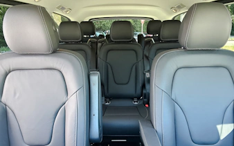 Interior of a black Mercedes-Benz transfer vehicle with leather seats.
