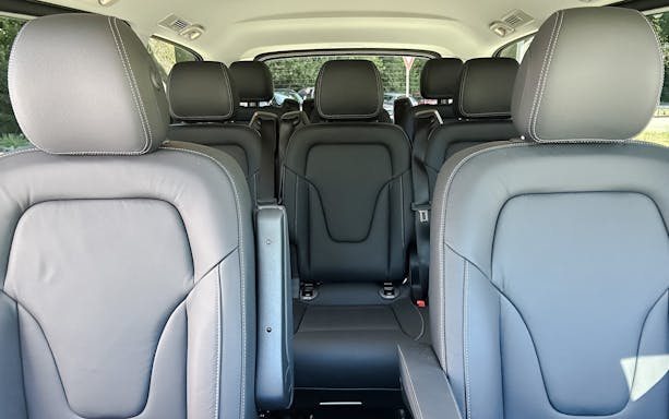 Interior of a black Mercedes-Benz transfer vehicle with leather seats.