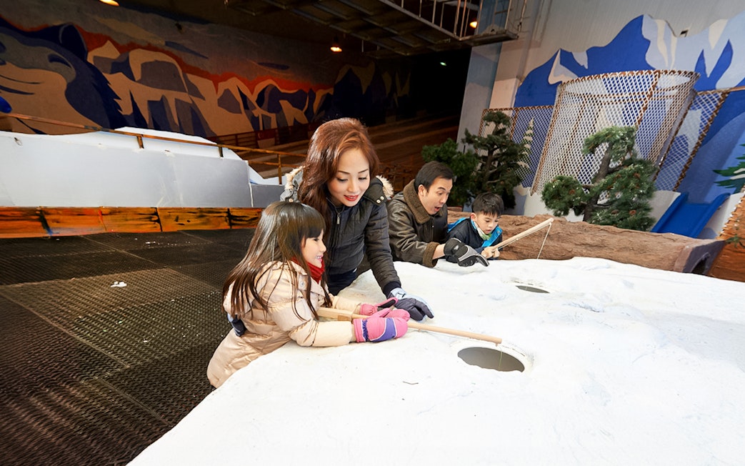 Family enjoying snow activities inside Singapore Snow City.