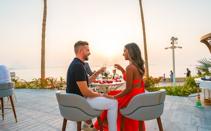 Couple enjoying a sunset dining experience at Uma Lounge, Burj Al Arab.