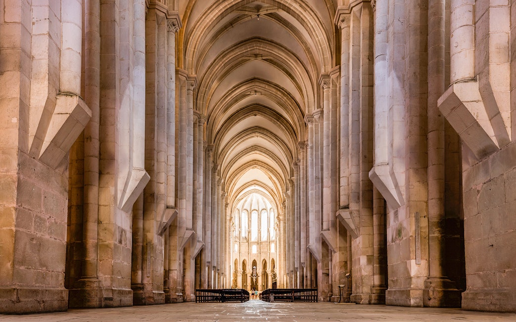 Alcobaça Monastery interior with vaulted arches and stone columns, Portugal.