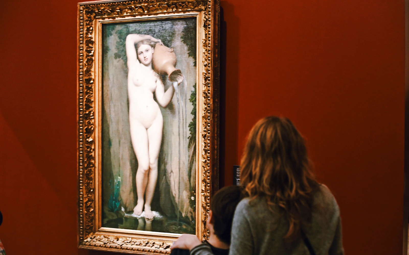 Visitors viewing a painting at Orsay Museum, Paris, France.