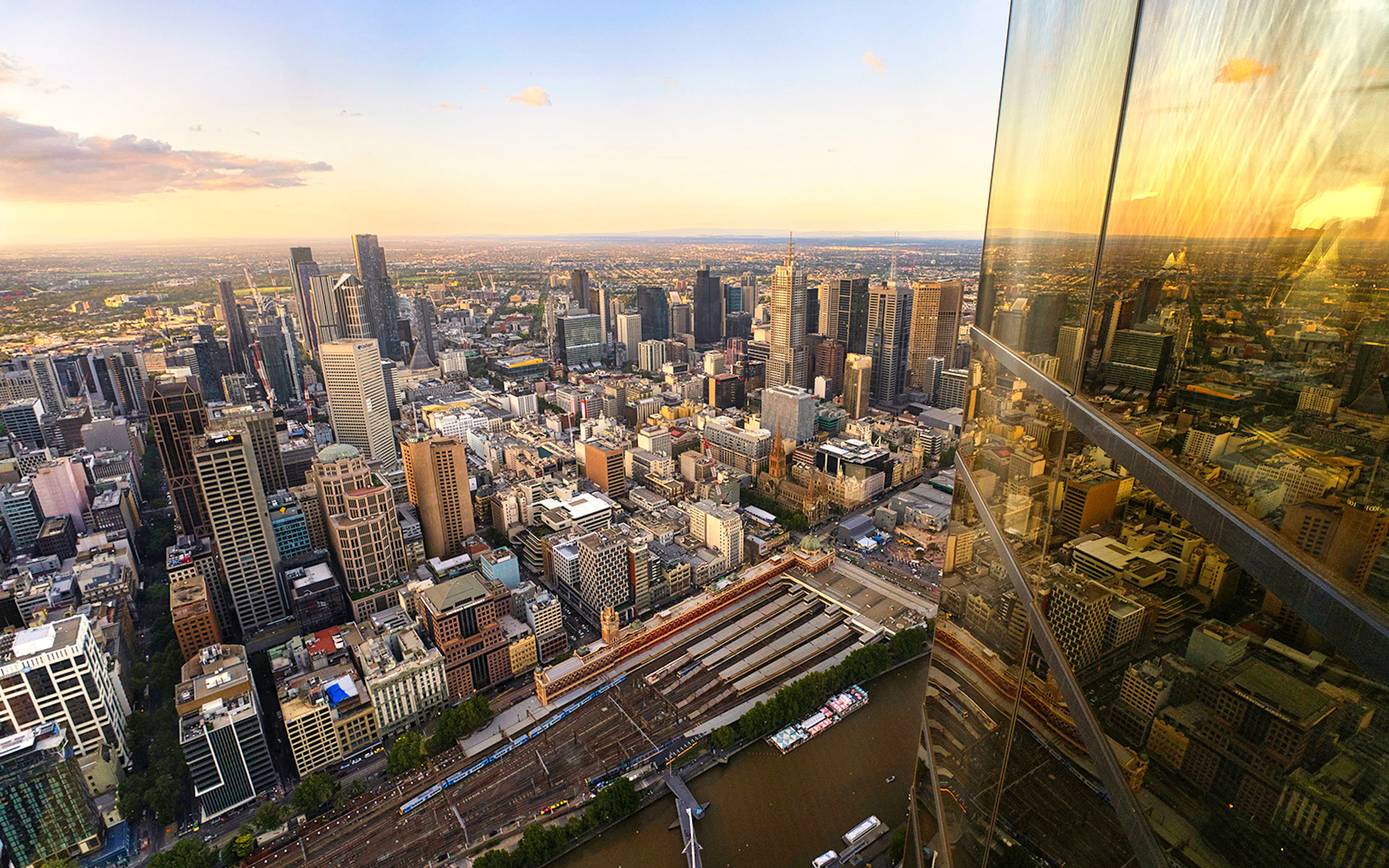 Melbourne cityscape view from Eureka Tower Skydeck, overlooking Yarra River and urban skyline.