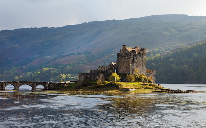 Eilean Donan Castle on a small island with a stone bridge, Isle of Skye, Scotland.
