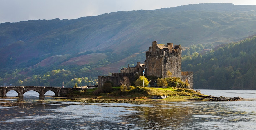 Eilean Donan Castle on a small island with a stone bridge, Isle of Skye, Scotland.