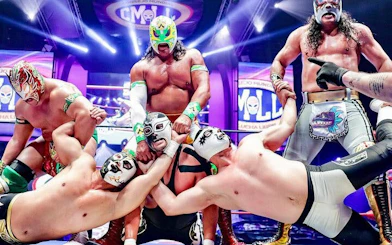 Lucha Libre wrestlers in colorful masks performing in a vibrant arena in Mexico City.