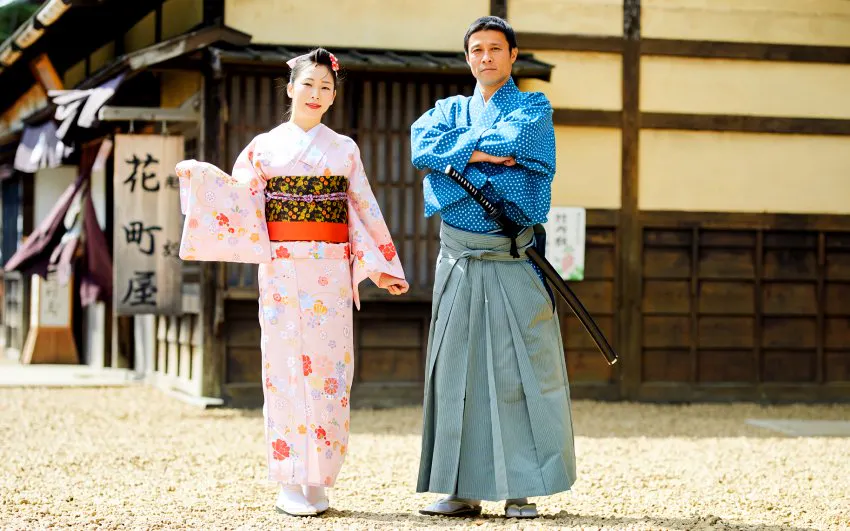Two people in traditional Japanese attire at Edo Wonderland Nikko Edomura.