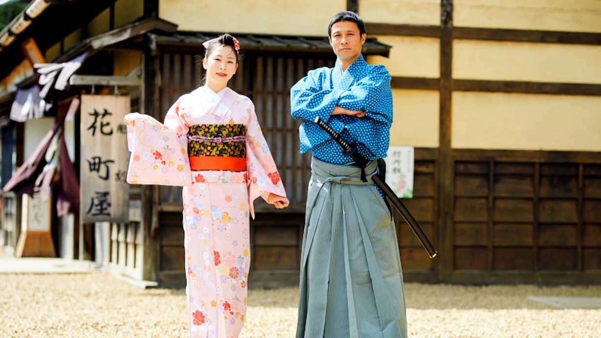 Two people in traditional Japanese attire at Edo Wonderland Nikko Edomura.