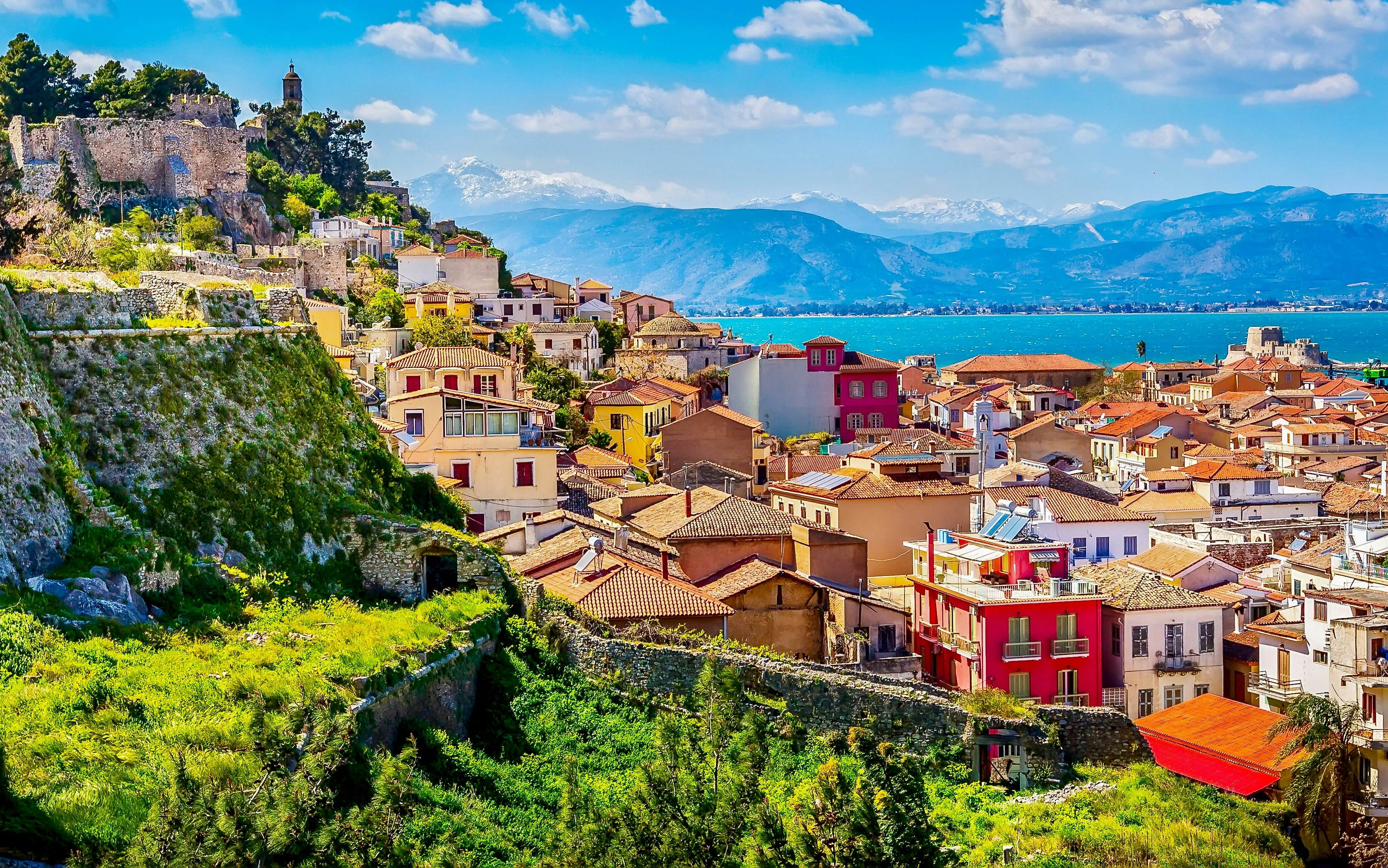 Aerial view of Nafplio, Greece with historic fortress and colorful buildings.