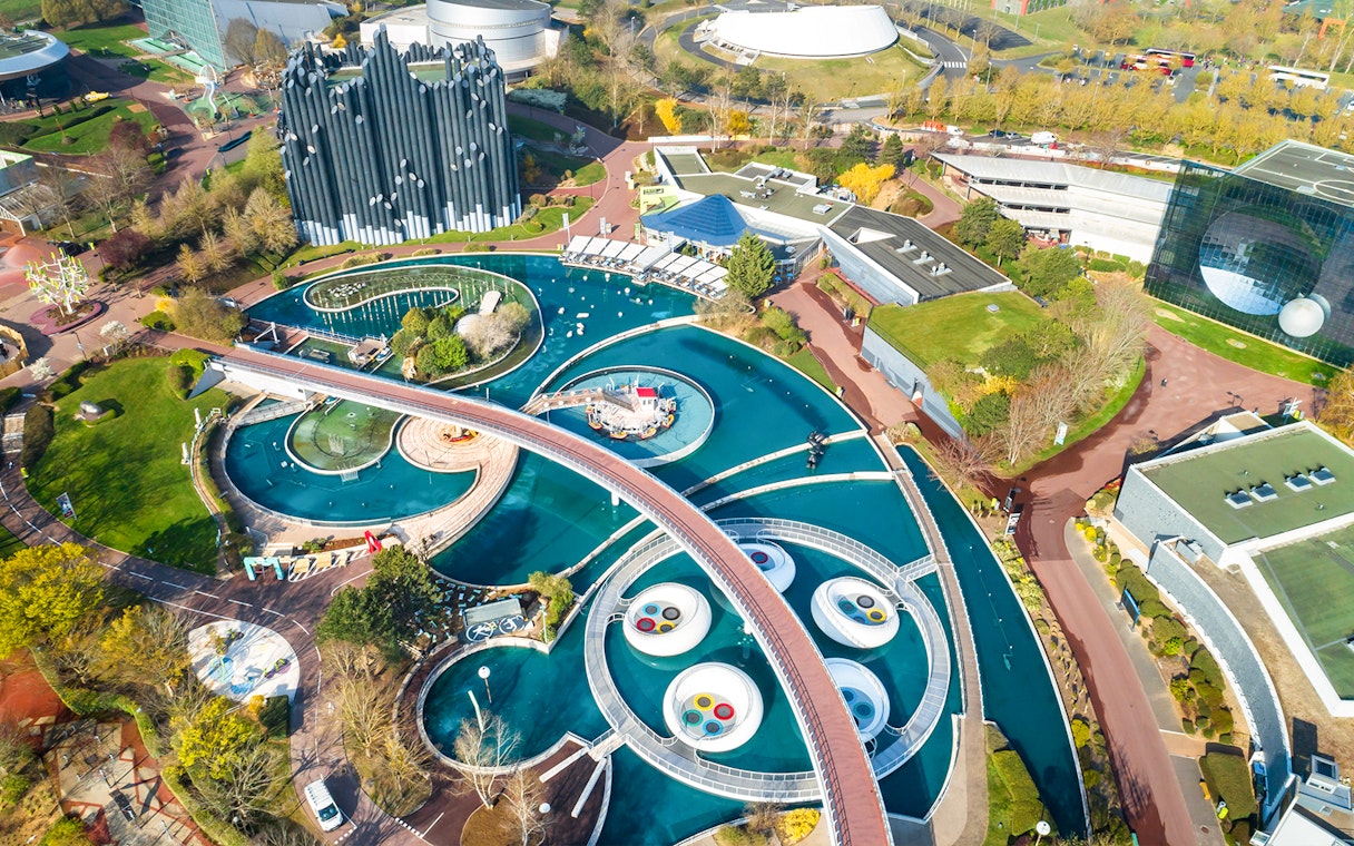 Aerial view of Futuroscope theme park with futuristic architecture and water features in Poitiers, France.