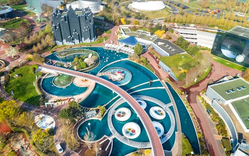Aerial view of Futuroscope theme park with futuristic architecture and water features in Poitiers, France.