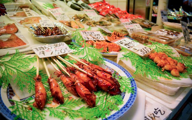 Grilled seafood skewers displayed at Kyoto Nishiki Market food tour.