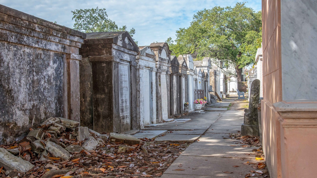 Lafayette Cemetery No. 1 tombs and pathway under trees in New Orleans.
