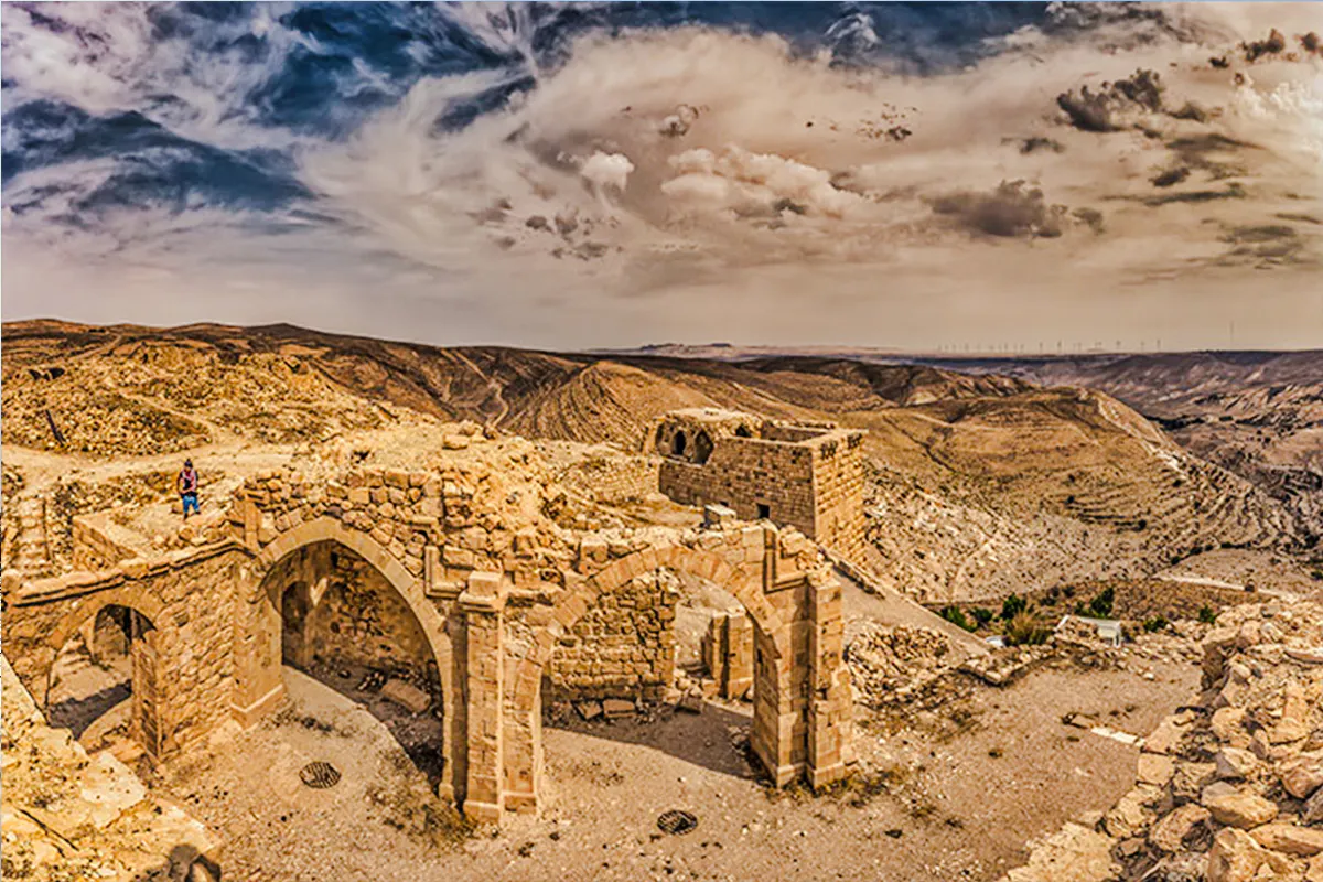 Ancient stone ruins at Ajloun Castle with expansive desert landscape, Jerash day trip.