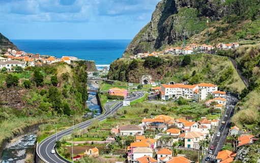 Cabo Girão cliffs and coastal village view on guided tour to Porto Moniz Lava Pools, Madeira.