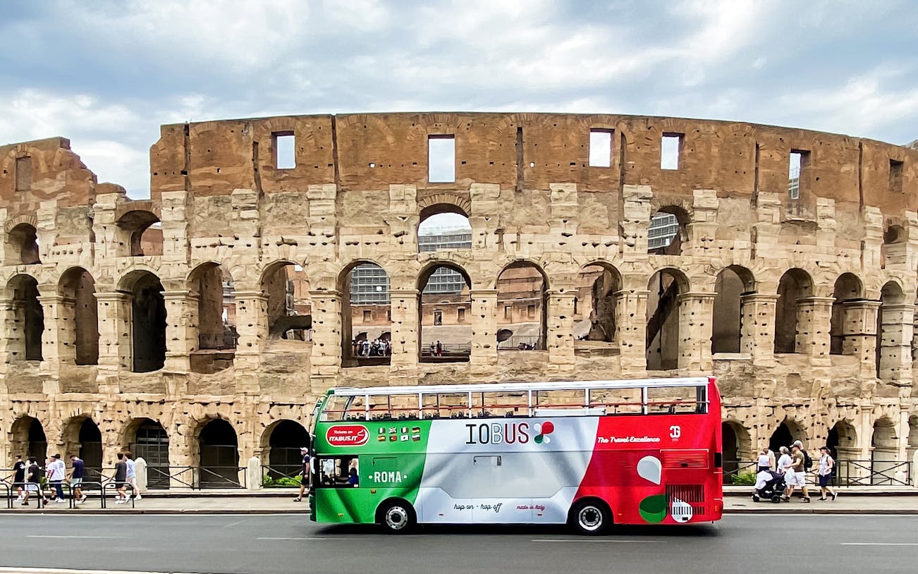 HOHO tour bus in front of the Colosseum, Rome.