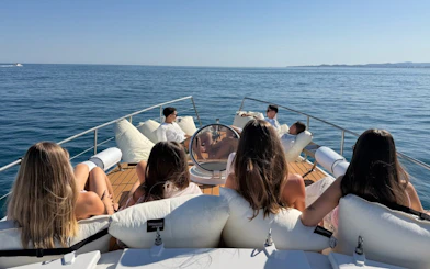 Small group relaxing on a yacht deck during Benalmádena dolphin-watching cruise.