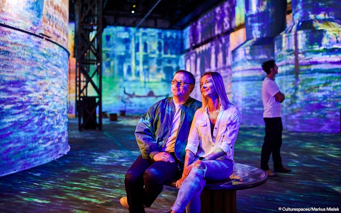 Guests enjoying immersive art projections at Phoenix des Lumières.