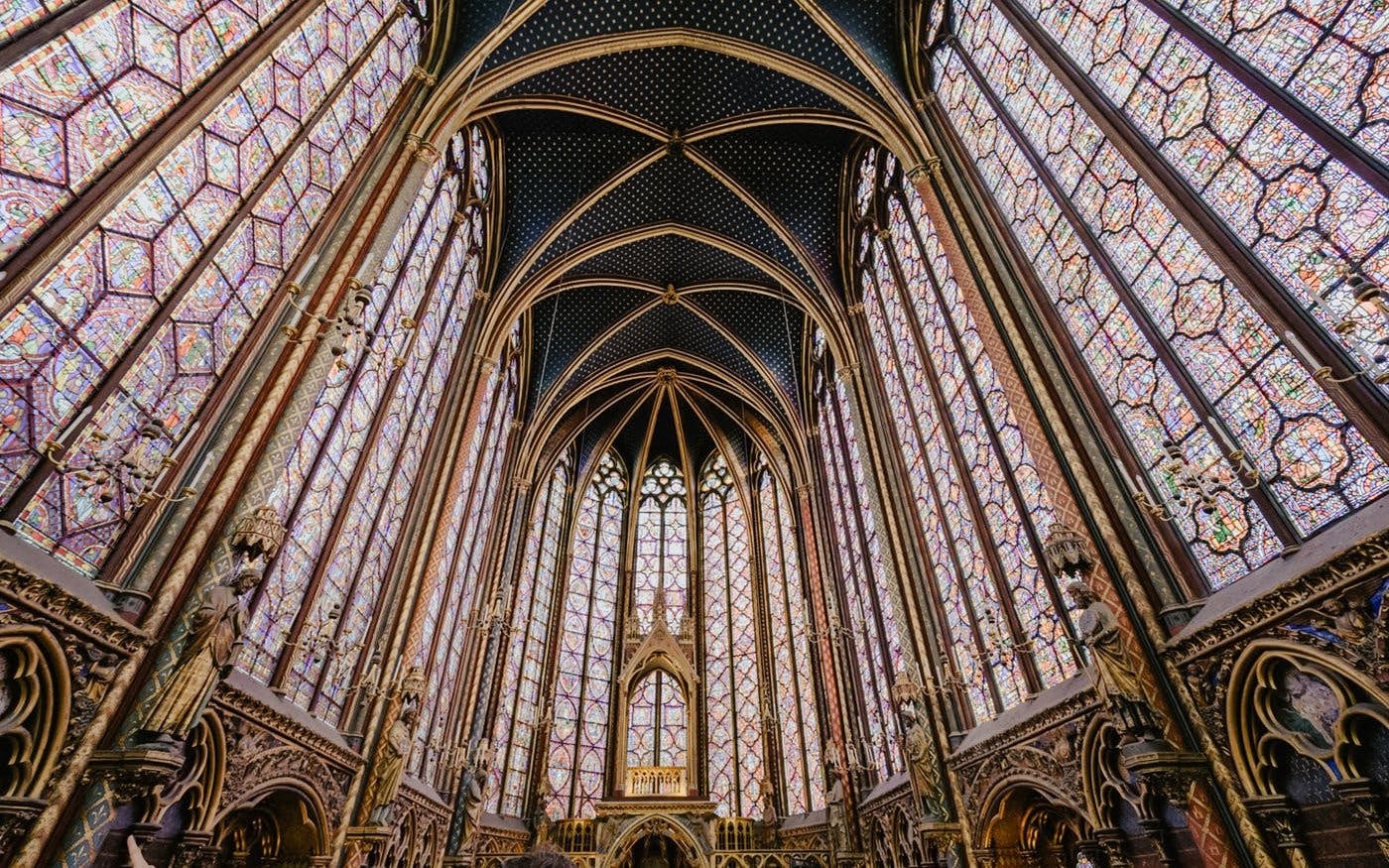 Sainte-Chapelle interior with ornate stained glass windows and vaulted ceiling in Paris.