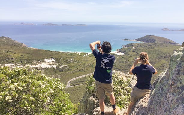 Tourists photographing coastal view at Wilsons Promontory, Australia.