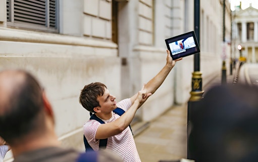 Guide showing Harry Potter film location on tablet during walking tour.