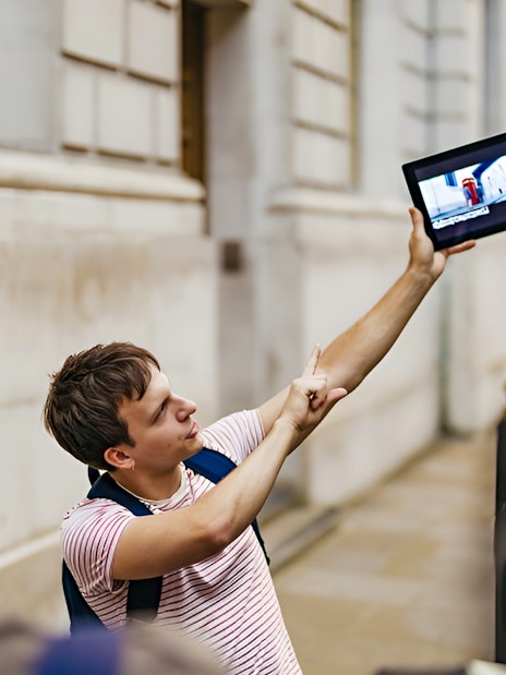 Guide showing Harry Potter film location on tablet during walking tour.