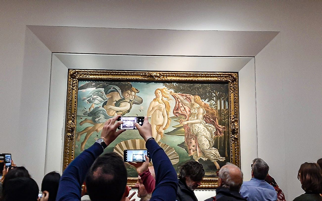 Visitors photographing Botticelli's "The Birth of Venus" at Uffizi Gallery, Florence.