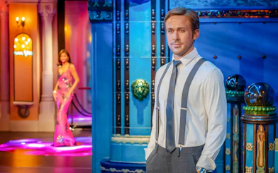 Wax figure exhibit at Madame Tussauds, Budapest featuring a man in formal attire.