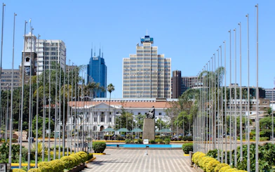 Nairobi cityscape with modern buildings and a statue, near Carnivore Restaurant Experience.