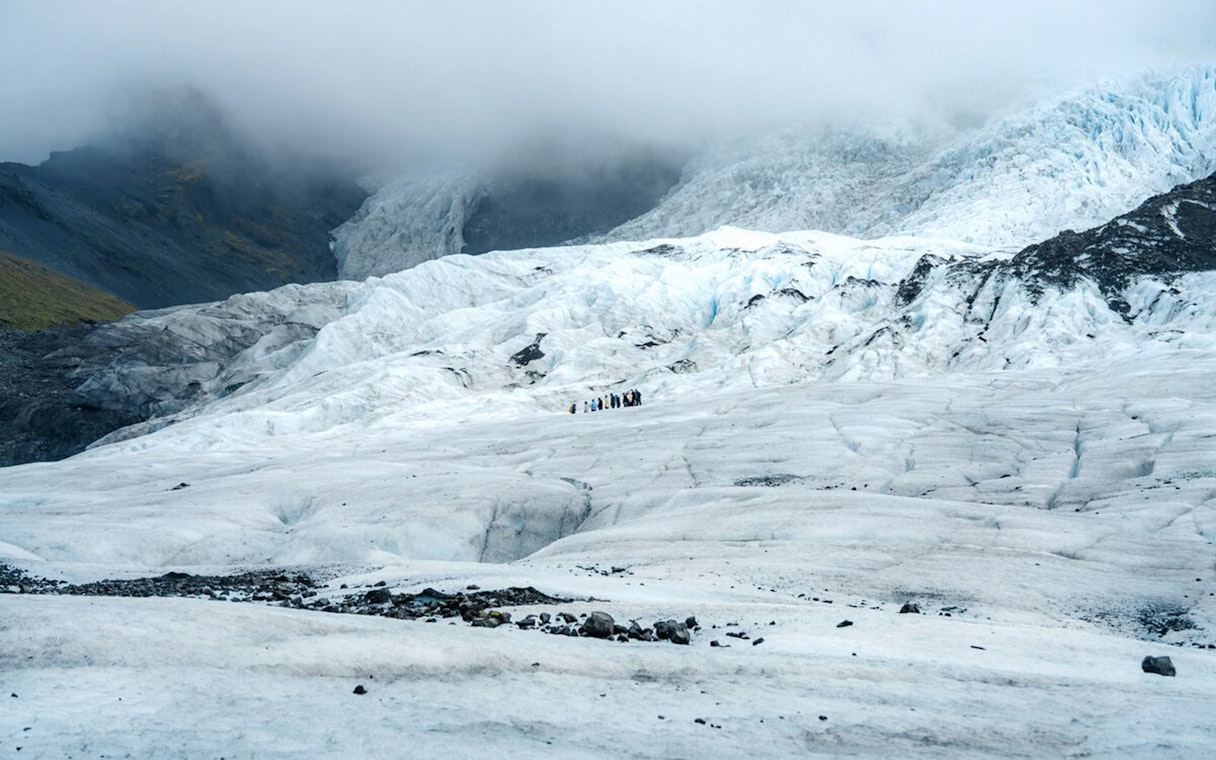 Vatnajökull Glacier with hikers exploring the icy landscape in Iceland.