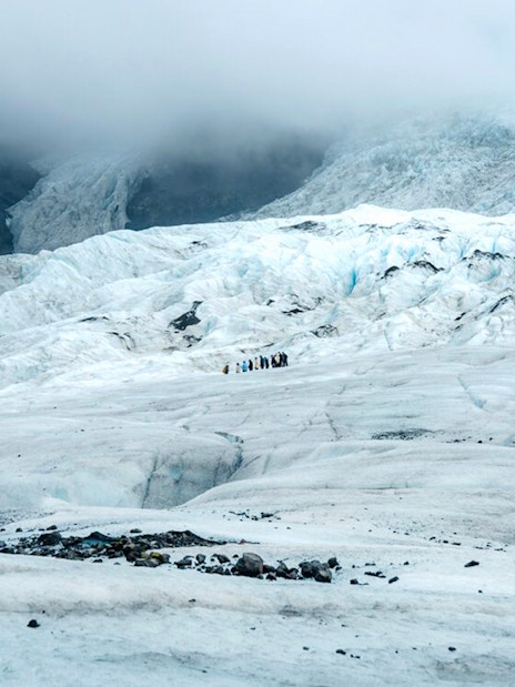 Vatnajökull Glacier with hikers exploring the icy landscape in Iceland.